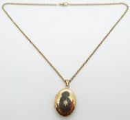 9ct gold locket set with a diamond of approximately 0.18ct in a star setting on 9ct gold chain/