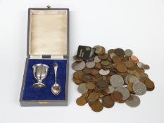 A cased hallmarked silver egg cup and spoon set, weight 51g and a quantity of coins including some