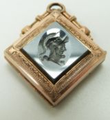 A yellow metal locket set with a hematite intaglio, verso inset with onyx