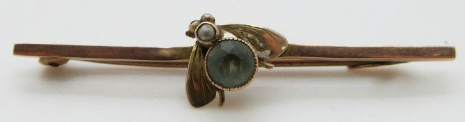 A 9ct gold brooch in the form of a fly set with a seed pearl and paste