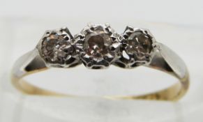An 18ct gold ring set with three diamonds in a platinum setting, size I
