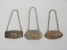 A set of three hallmarked silver bottle tickets for whisky, gin and port, each London 1977, maker'