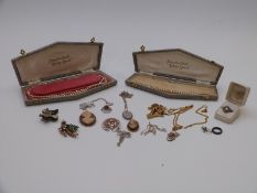 A silver ring set with marcasite, silver scarf ring, 9ct gold and silver ring, silver locket and