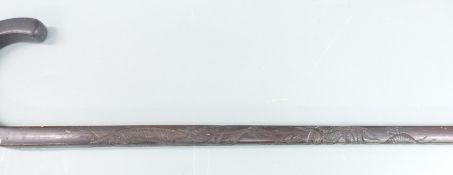 A carved Chinese walking stick with dragon decoration