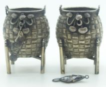 Pair of Chinese white metal salts formed as woven baskets on stands with articulated hanging fish,