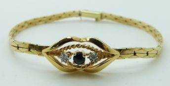 A 14k gold bracelet set with a sapphire and two diamonds, 8.6g
