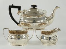 George V hallmarked silver three piece tea set comprising teapot, Chester 1935 and jug and sugar