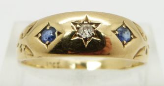An 18ct gold ring set with a diamond and two sapphires, Birmingham 1896, size R