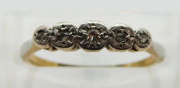 An 18ct gold ring set with five diamonds in an illusion setting, size L