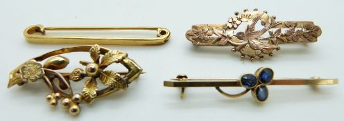 An 18ct gold brooch set with sapphires in a clover, a 9ct gold floral brooch, a 9ct rose gold brooch