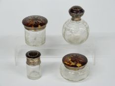 Set of four hallmarked silver and tortoiseshell pique work topped cut glass dressing table