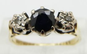 An 18ct gold ring set with a sapphire and diamonds, size L