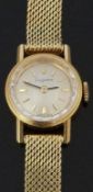 Dugena 18ct gold ladies wristwatch with black hands, gold baton markers, silver dial, bevelled bezel