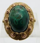 A 14k gold ring set with an azurite cabochon, with textured detail to the setting, marked W9H,  size