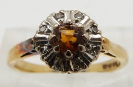 An 18ct gold ring set with a citrine and diamonds, size K