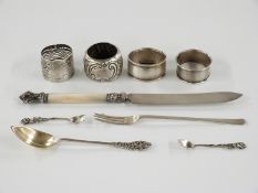 Three hallmarked silver napkin rings, hallmarked silver pickle fork and a part gilt spoon marked