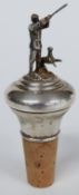 Modern silver bottle stopper depicting a shooting scene with dog beside, height 10.5cm