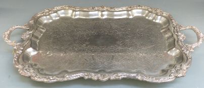 A large twin handled silver plated tray raised on four feet, length 75cm