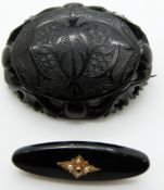 Victorian jet brooch set with seed pearls and a diamond and a jet brooch with engraved detail and