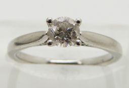 A platinum ring set with a round brilliant cut diamond of approximately 0.5ct, size K
