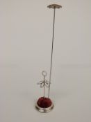 A silver hat pin stand, Chester 1921, together with a vintage hat pin.