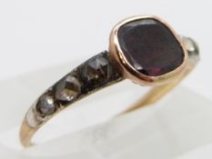 Georgian / Victorian ring set with a foiled garnet and three rose cut diamonds to each shoulder,