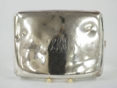 A curved hallmarked silver cigarette case, Birmingham 1918 maker Williams Ltd, width 11.5cm,