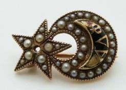 Victorian brooch set with seed pearls and enamel in a crescent and star design