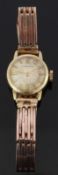 Huguenin 14ct gold ladies wristwatch with gold hands and baton markers, champagne face and signed 17