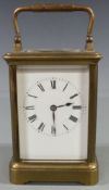 Early twentieth century French brass carriage clock in corniche style case, with white enamel dial