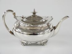 George V hallmarked silver teapot with shaped edge, raised on lion's paw feet, Sheffield 1921