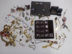 A collection of costume jewellery to include glass beaded necklace, badges, brooches, necklaces etc