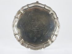 Elkington and Co George VI hallmarked silver card tray with a shaped edge and raised on three