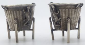 Pair of Chinese white metal salts formed as woven tapered baskets on stands with lizards to one