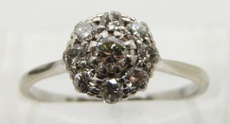 An 18ct gold ring set with diamonds in a platinum cluster, size N