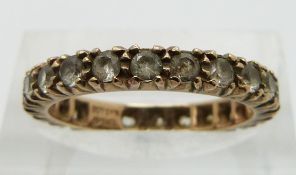 A 9ct gold eternity ring set with synthetic spinel, size L