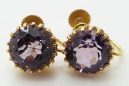 A pair of 9ct gold earrings set with an amethyst to each