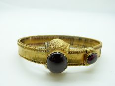 Victorian Etruscan Revival gold bracelet set with two large foiled garnets and engraved