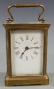 Early to mid twentieth century brass carriage clock in corniche style case, with white Roman dial