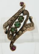 A rose gold ring set with emeralds, rubies and diamonds