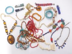 A collection of costume jewellery, necklaces including bone, agate, pearl, amber, coral and