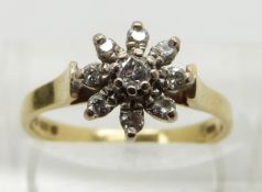 An 18ct gold ring set with diamonds in a flower cluster, size M