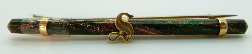 A brooch set with sunstone with yellow metal fittings