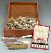 A large collection of silver plated cutlery, cased set brushes etc