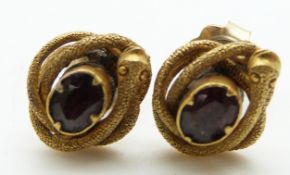 A pair of Victorian earrings set with foiled garnets surrounded by snakes with textured detail