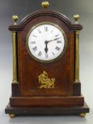 Georgian mantel clock, the enamel Roman dial with steel spade hands, the inlaid mahogany veneered