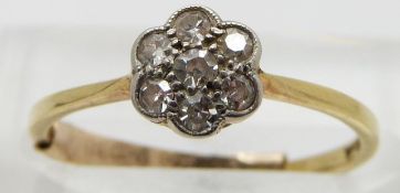 An 18ct gold ring set with diamonds in a cluster, size K