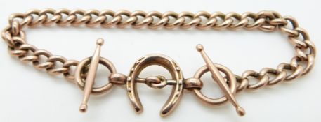 A 9ct rose gold curb link bracelet with horseshoe and bridle decoration and four spare links, 8.8g