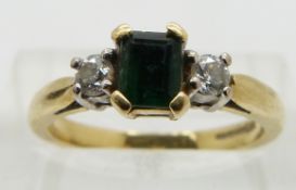 An 18ct gold ring set with an emerald and diamonds