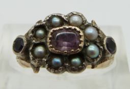 An early Victorian ring set with foiled amethysts and pearls, size N